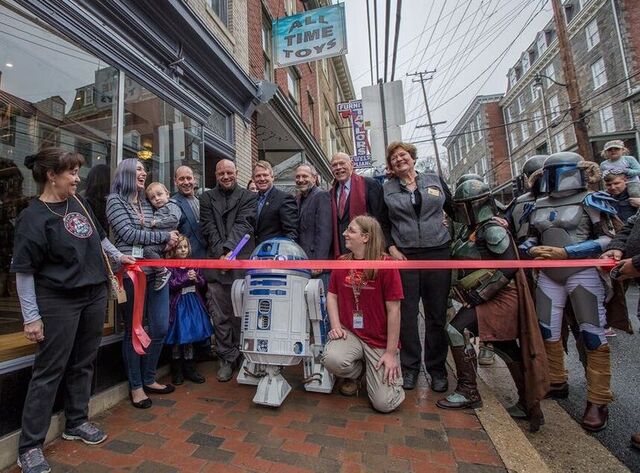 All Time Toys reopening celebration, with a red ribbon, R2-D2 and costumed Star Wars characters