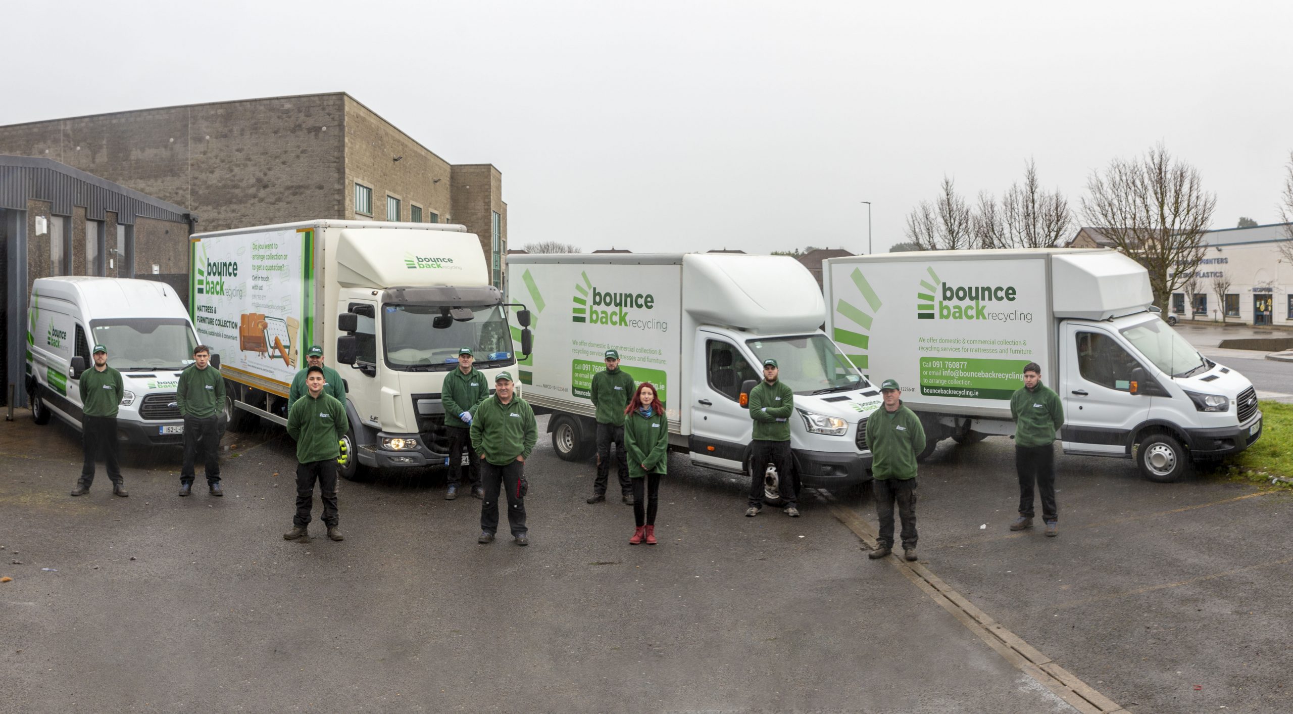 Bounce Back Recycling team standing in front of its collection vehicles