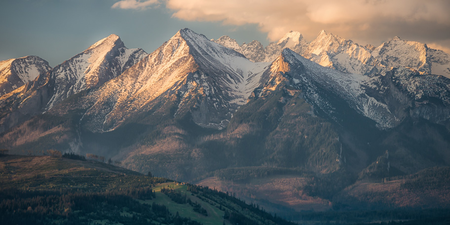 Snow-dusted mountain peaks at sunrise