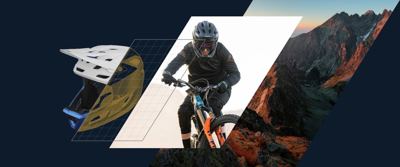 A mountain biker in a full-face Bell helmet rides a rocky trail beside an engineering grid and a mountain range