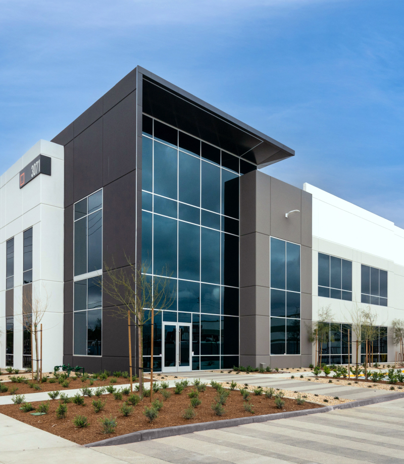 Rexford industrial property with a glass entrance and warehouse extending behind it