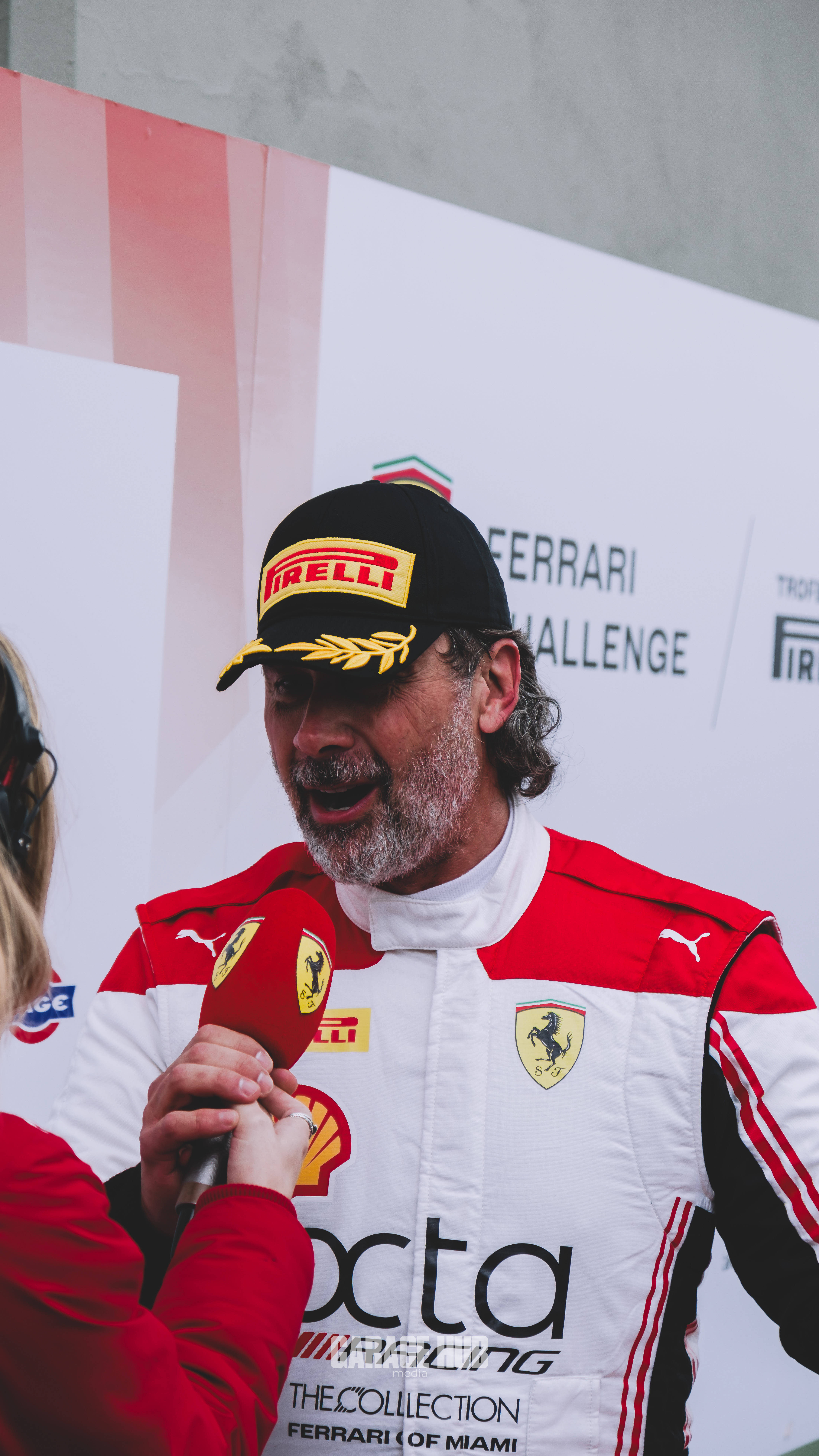 Rey Acosta being interviewed in his Ferrari racing suit at the 2025 Finali Mondiali