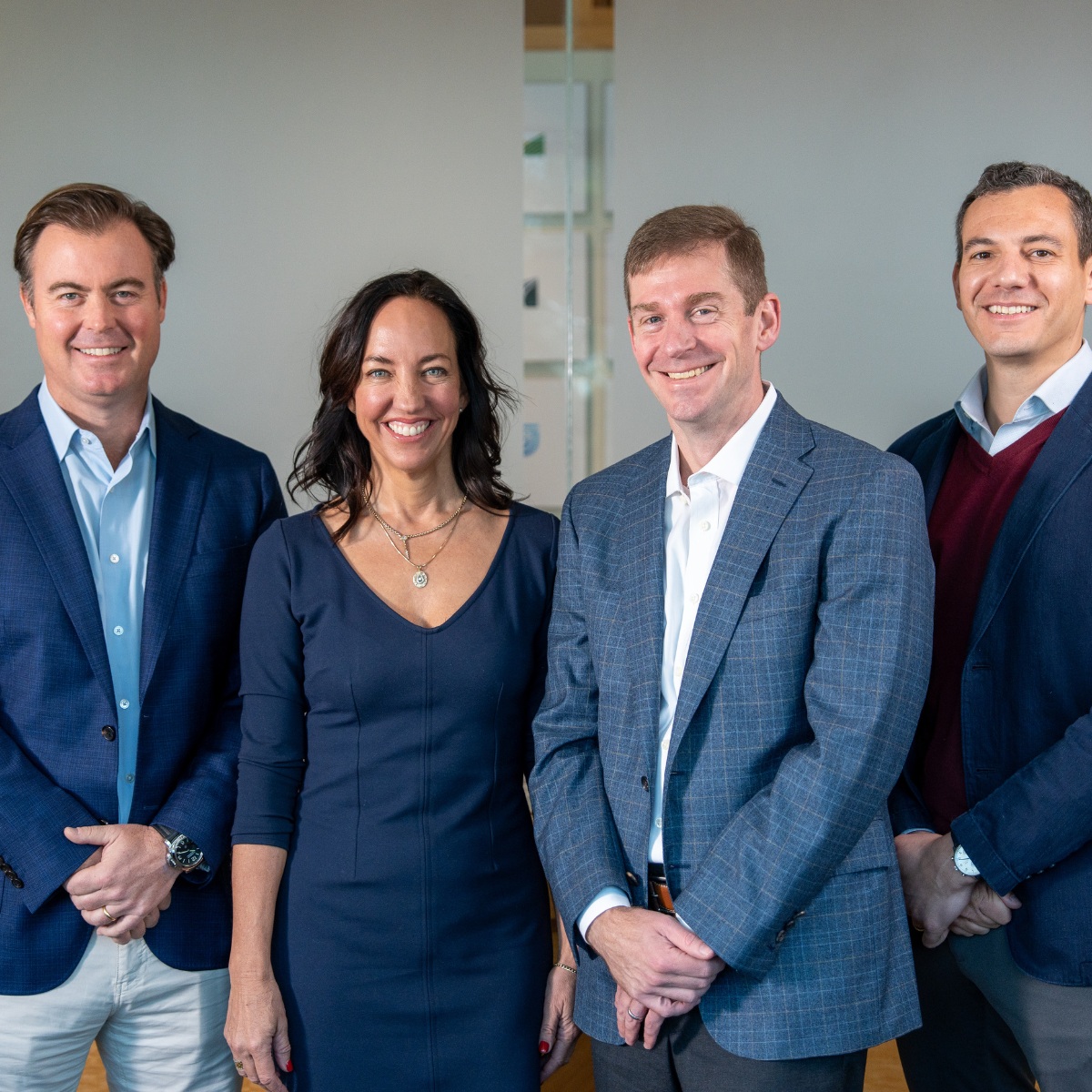 Four members of RFG Advisory’s executive team standing together in an office