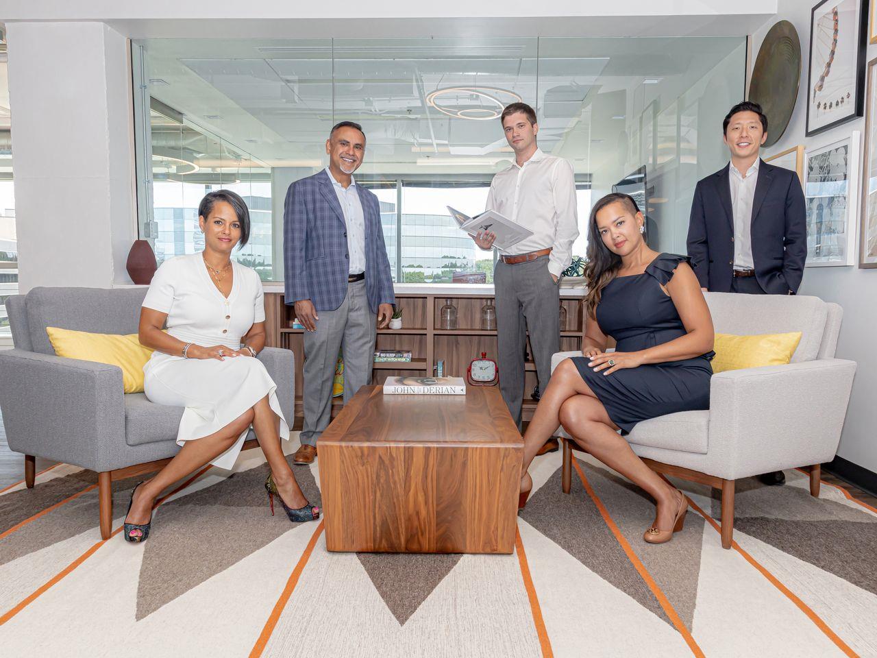 Rhonda Bray seated at left with Mirza Baig, Matt Lowen, Andrea Clark and Edward Chung in a 2021 group photograph.