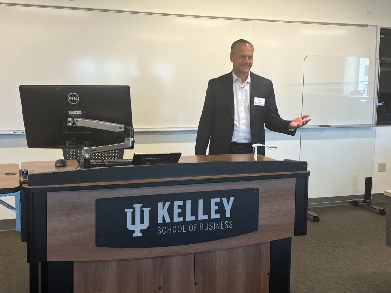 Ric Phillips speaking at a lectern at Indiana University's Kelley School of Business