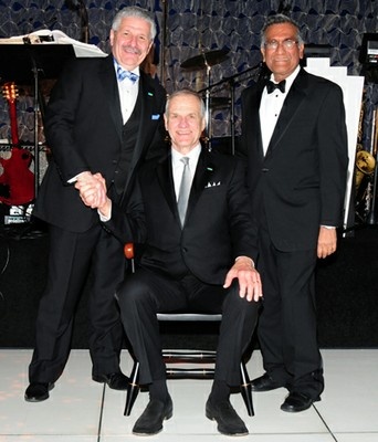 John M. Dionisio stands beside seated Richard G. Newman, with UCLA dean Vijay K. Dhir on the right