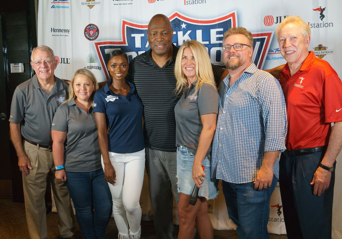 Richard Collins, at far right in an orange Istation shirt, with Charles Haley and fellow participants at a Tackle Tomorrow fundraiser.