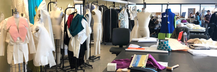 Dress forms, fabric and worktables in a Drexel design studio