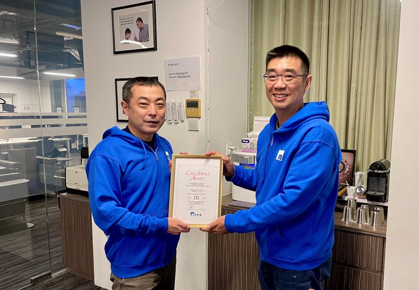 Richard Koh presenting a long-service award to his chief technical officer