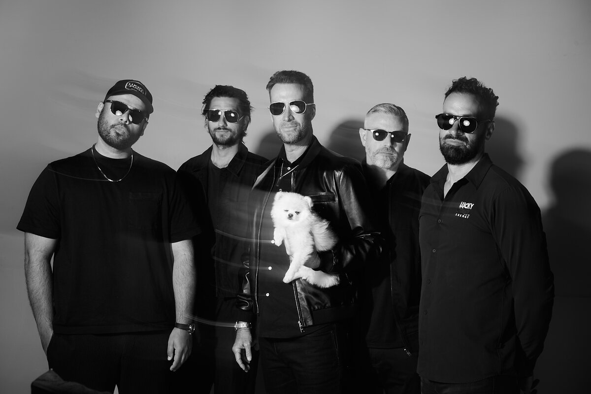 Richard Laver, center holding a small white dog, with Lucky Energy’s 2024 leadership team in sunglasses