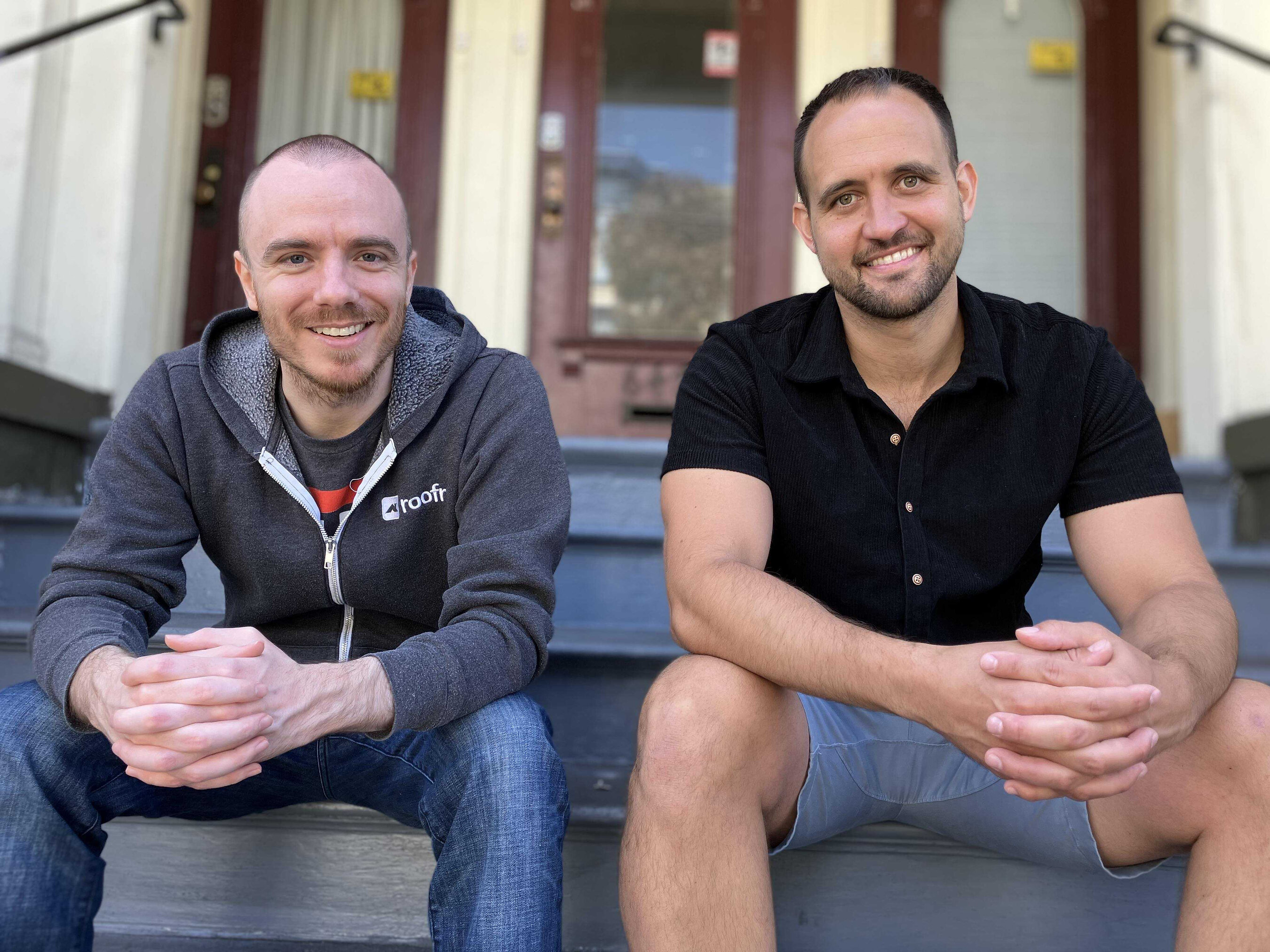 Roofr co-founders Kevin Redman, left, and Richard Nelson, right, seated on outdoor steps.