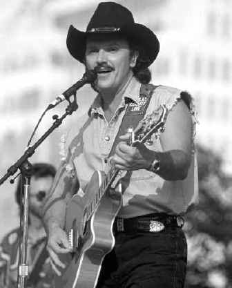 Richard Scrushy wearing a cowboy hat and playing guitar with Dallas County Line in Birmingham in 1995
