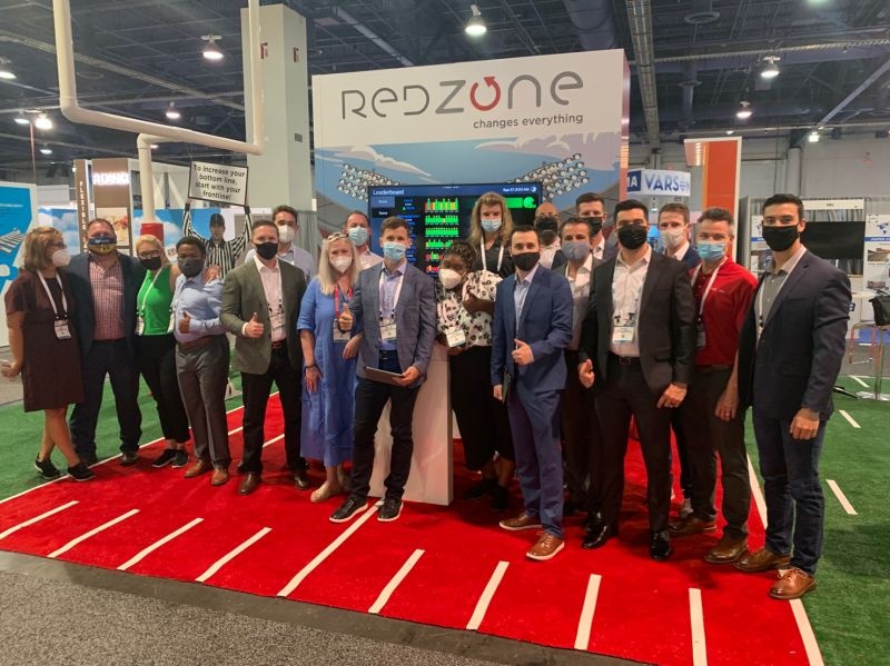 The Redzone team gathered at its football-themed PACK EXPO booth in 2021