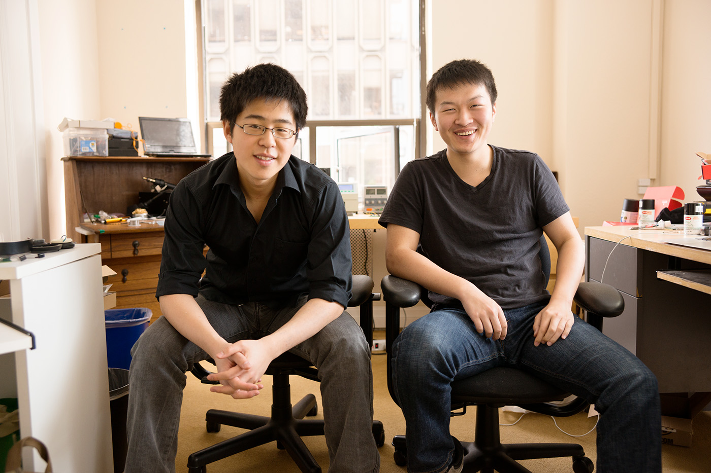 Wearhaus co-founders Nelson Zhang, left, and Richie Zeng, right, seated in a workspace