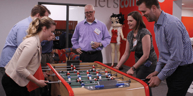 Guests playing foosball in the Austin Williams office