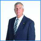 Archival photograph of Rick Frost in a dark suit, published with his Beacon board biography