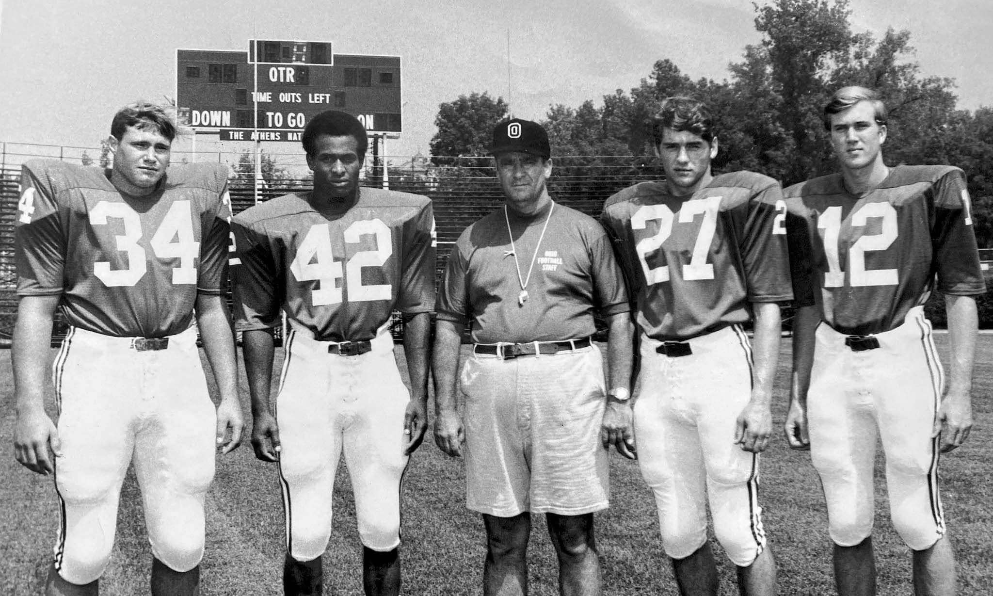 Rick Hawkins, wearing number 27, with fellow Ohio football players and a coach