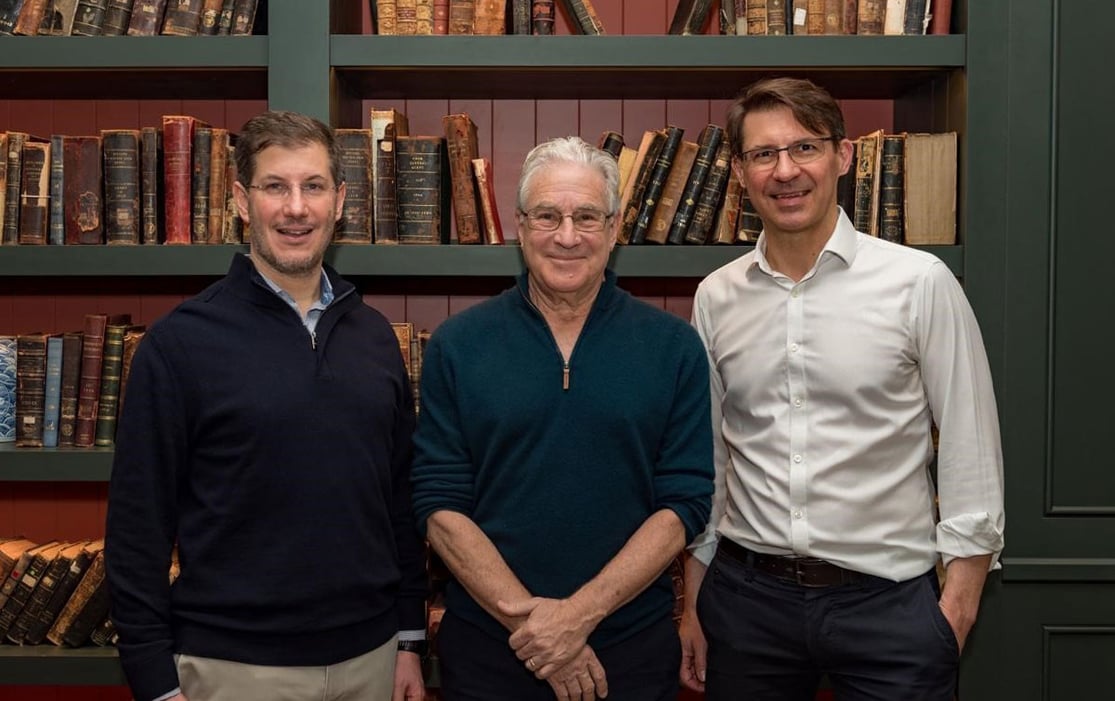 Florian Schuster, Rick Klausner and Mark Kotter standing together in front of bookshelves