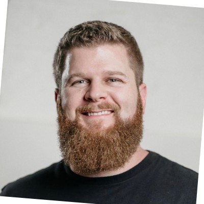Rick McCartney smiling in a black T-shirt