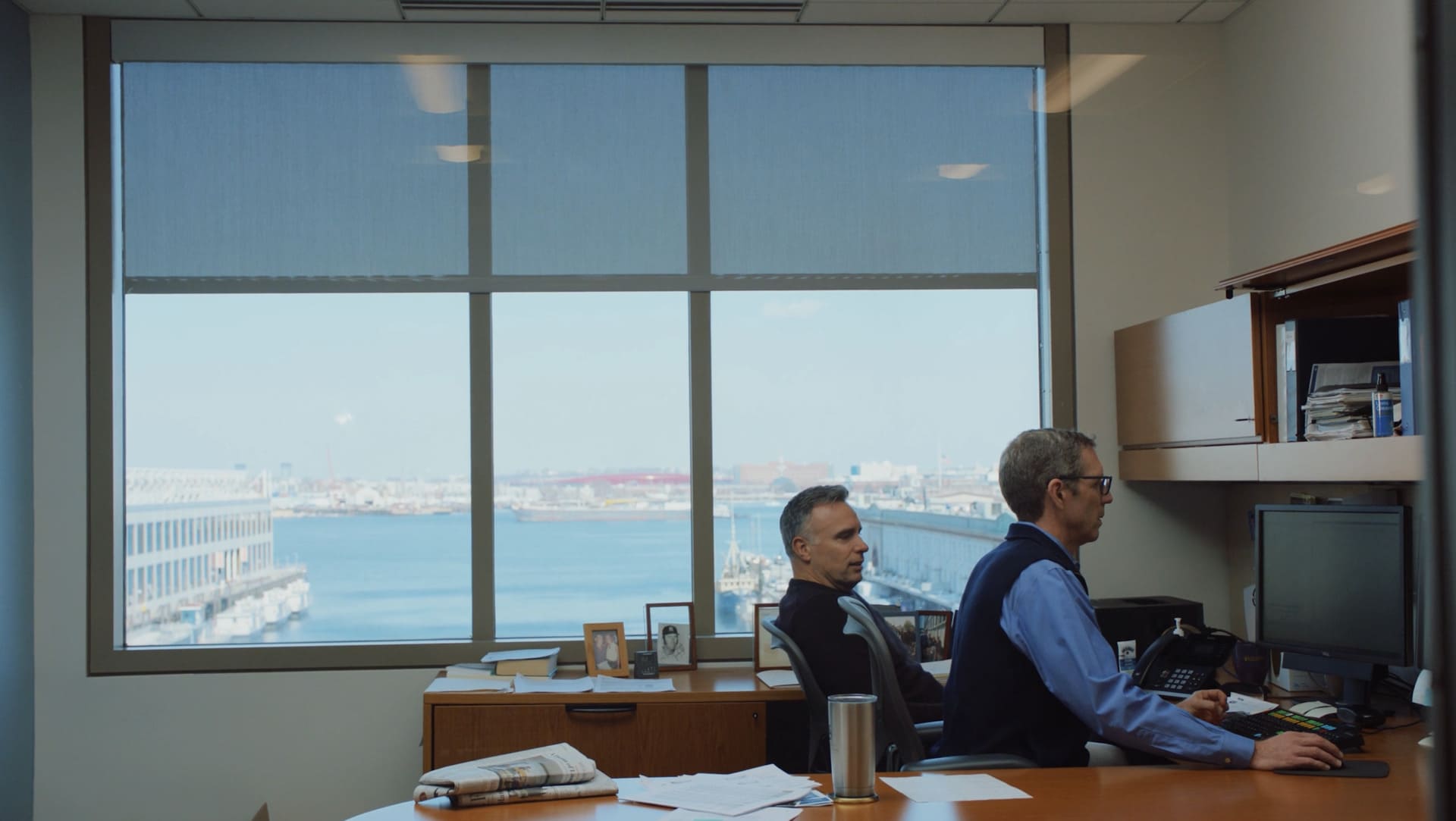 Congress Asset Management’s Dan Lagan and Brian Strang working together at a computer in a waterfront office