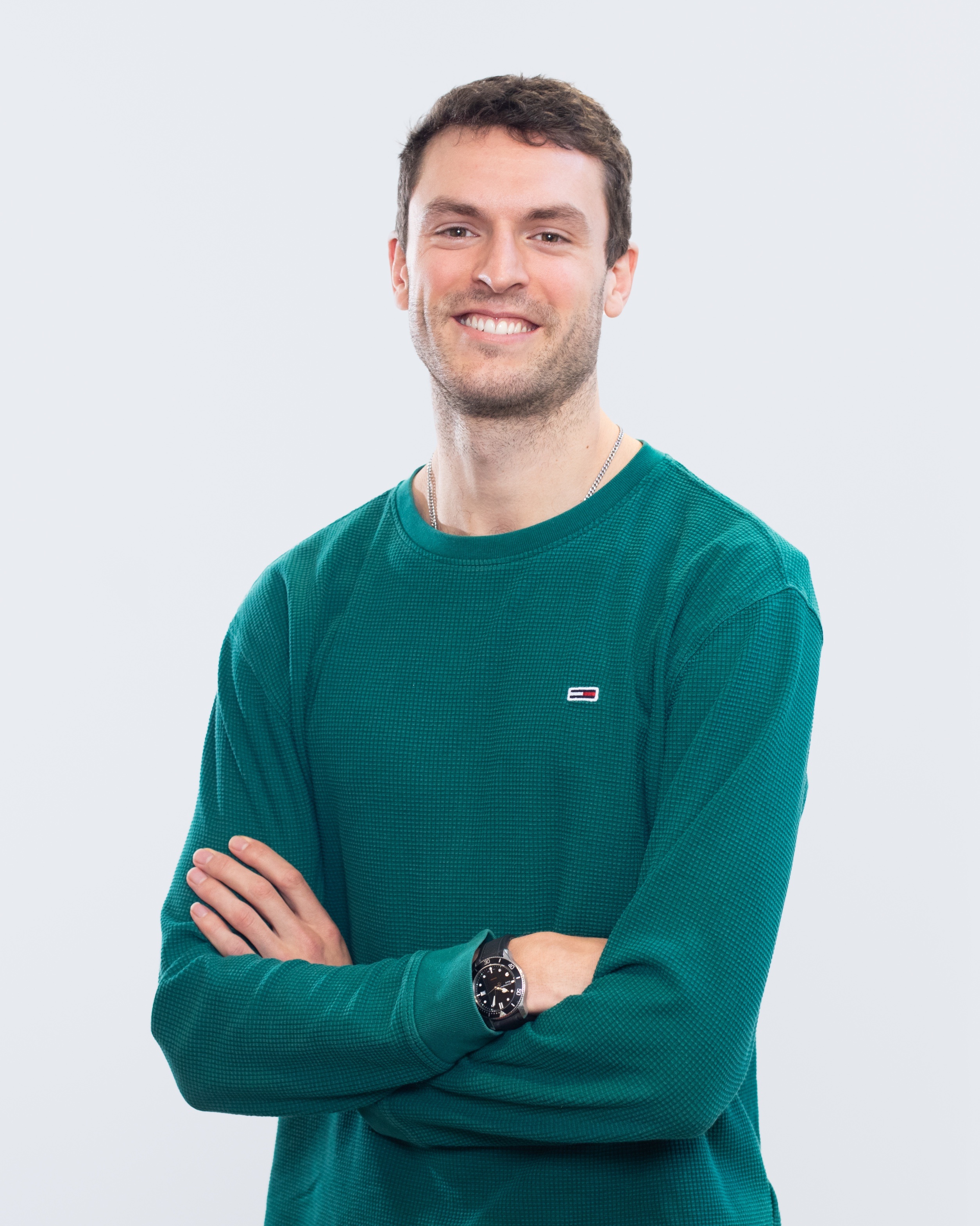 Riding Unicorns co-host Hector Mason wearing a green sweater
