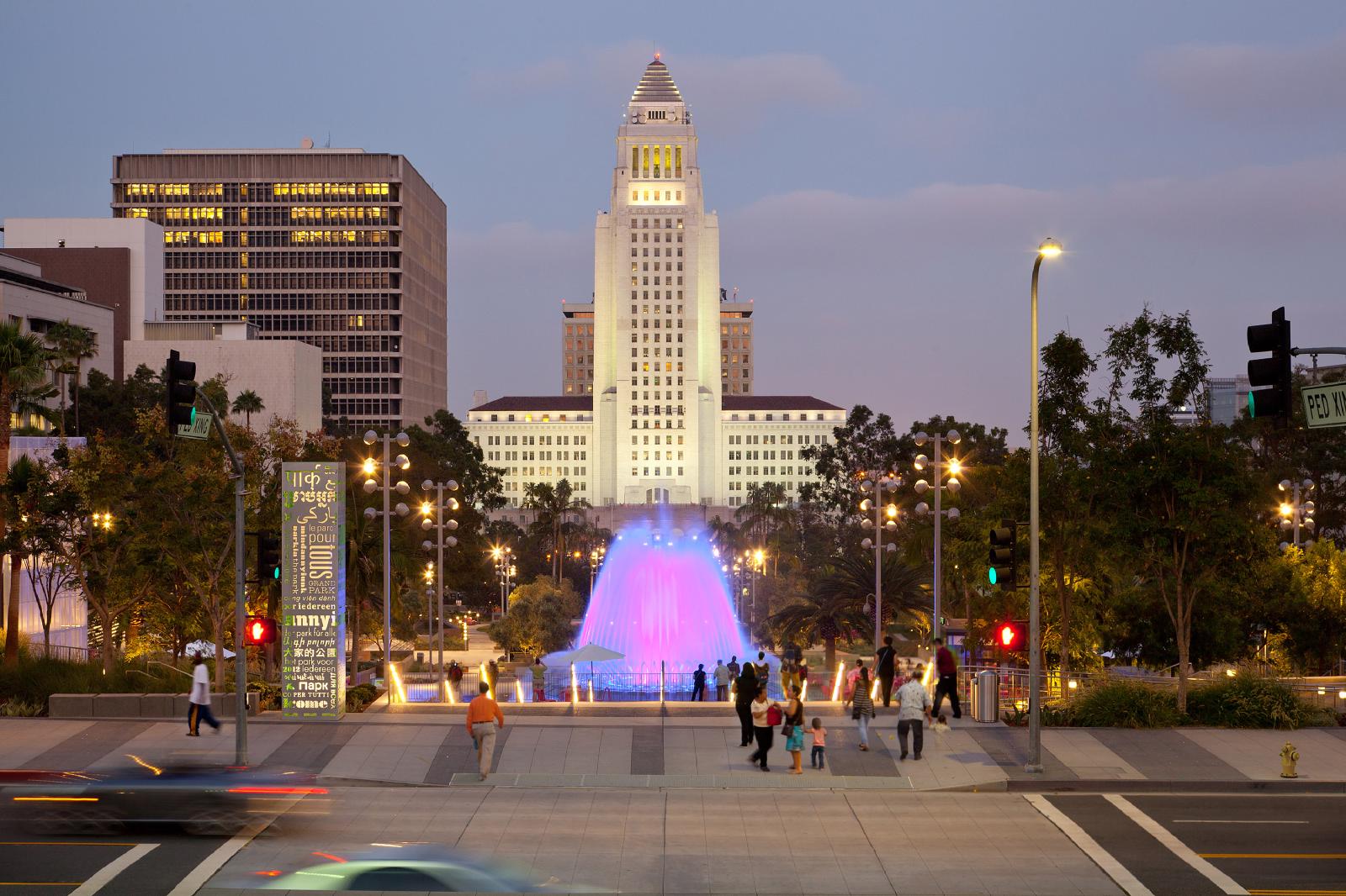 Grand Park at dusk, with its illuminated fountain and Los Angeles City Hall beyond