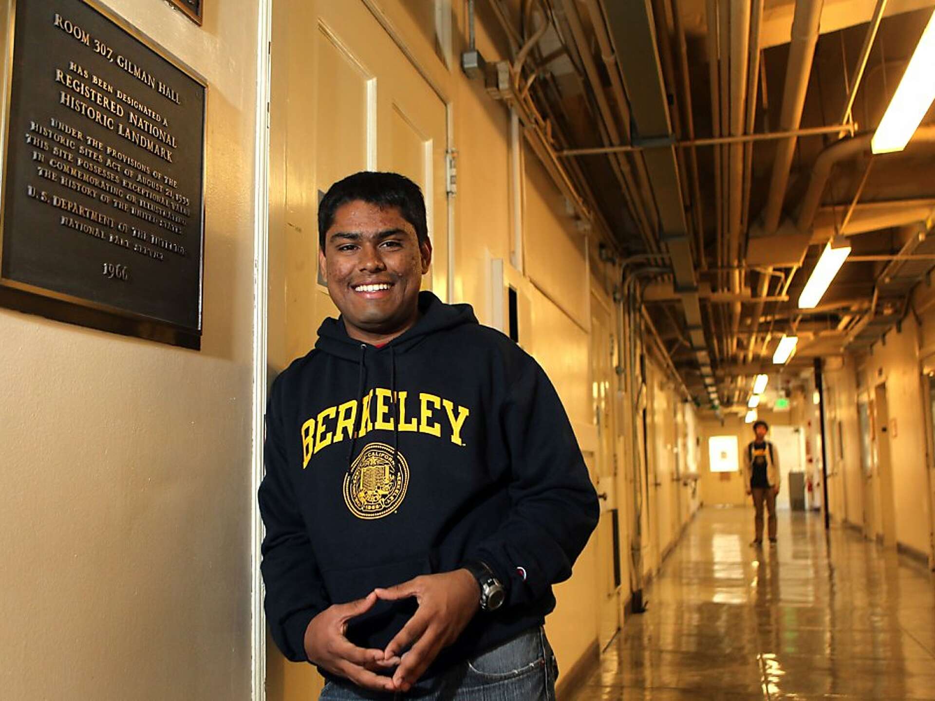 Ritankar Das in a Berkeley sweatshirt outside the historic Room 307 at Gilman Hall