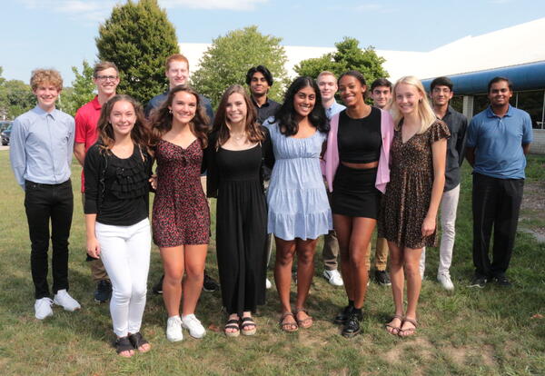 Pleasant Valley’s fourteen National Merit semifinalists posing outside their school in 2021