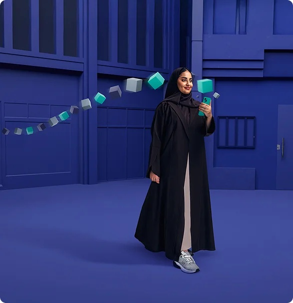 Riyad Bank annual-report campaign image showing a woman holding a smartphone against a blue architectural backdrop
