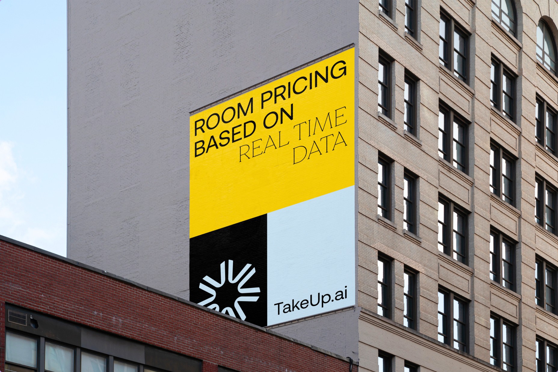 TakeUp brand mockup showing a yellow billboard with hotel pricing messaging and its repeated greater-than symbol
