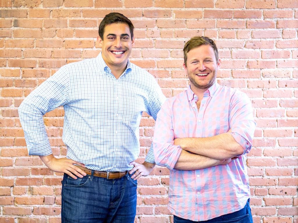 Rob Biederman, left, and Catalant co-founder Pat Petitti standing beside a brick wall