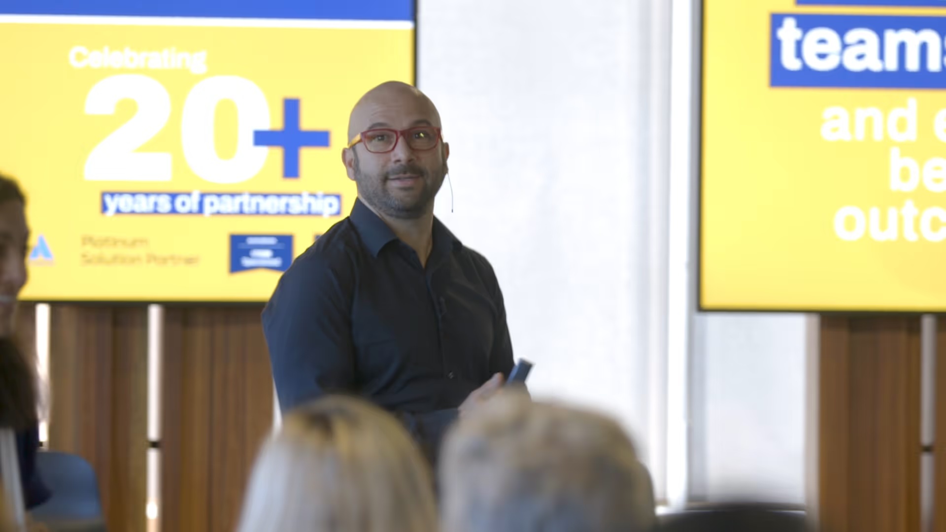 Rob Castaneda speaking to an audience at a ServiceRocket executive event in Australia