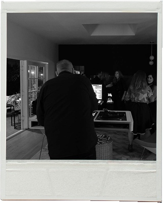 Rob Jalil seen from behind at DJ equipment during a gathering