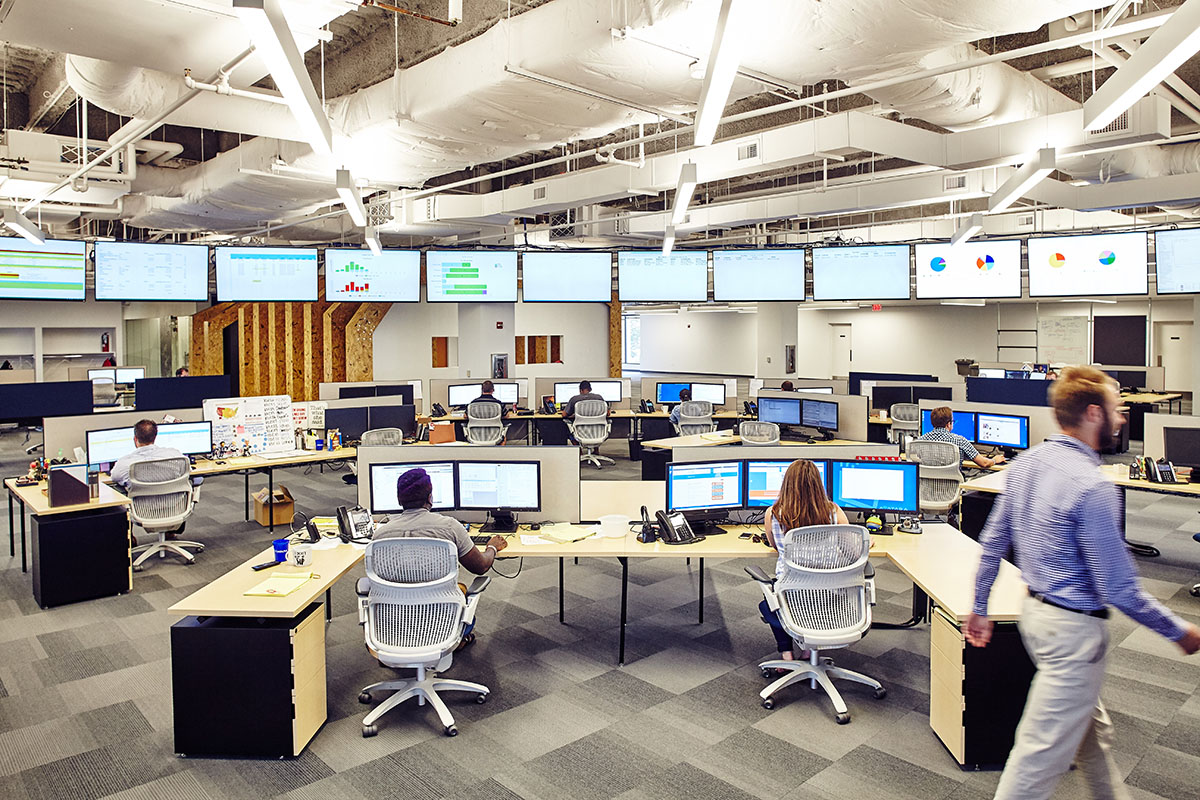 Avatara's open office with workstations and a row of operational displays