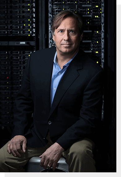 Rob McCormick seated in front of server racks