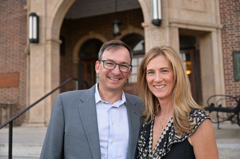 Rob and Pam Sharps smiling outside Stephens Hall at Towson University
