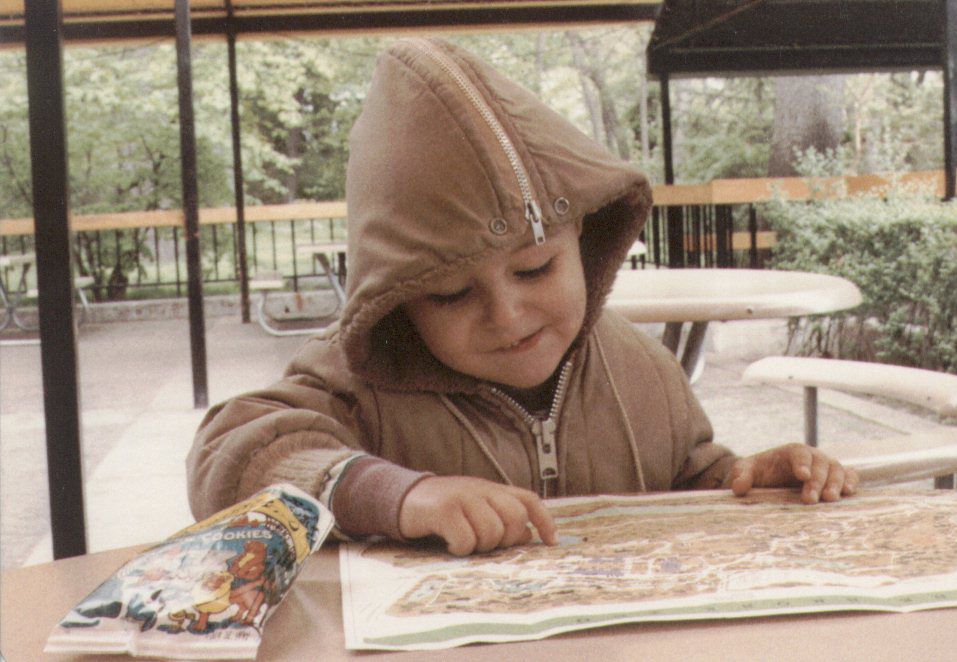 Rob Sobers as a child studying a map at the Bronx Zoo