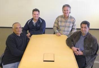 iTradeNetwork executives around a conference table in 2007: Chuck Gragg, Jim Corbett, Robert Bonavito and Zia Zahiri.