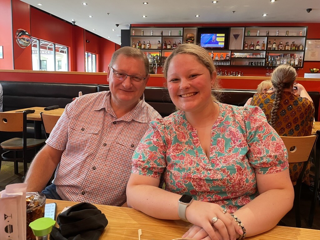 Robert Chambless and intern Ava Meiner seated together at a restaurant table