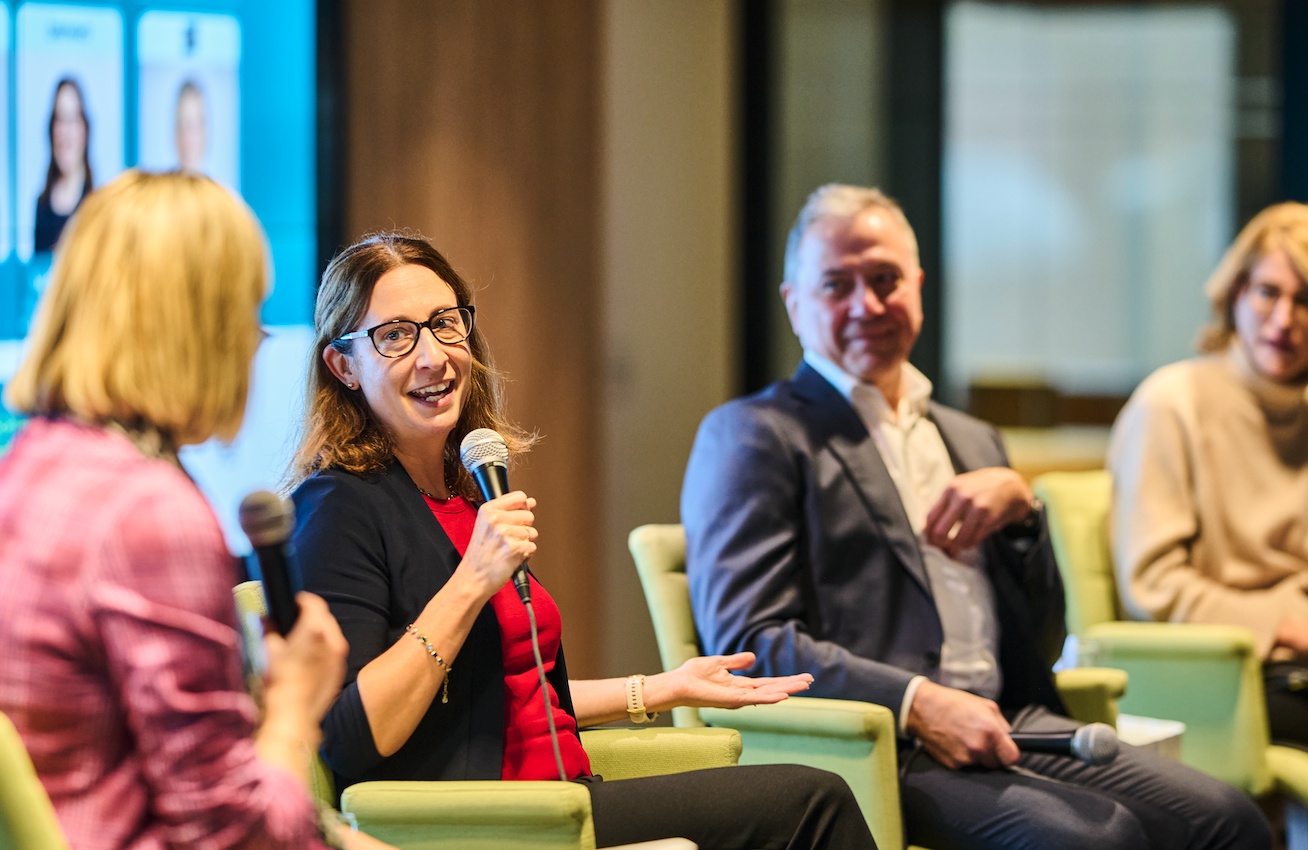 Mélissa Gilbert speaking on a panel, with Robert Dumas seated beside her and Annick Guérard at the right
