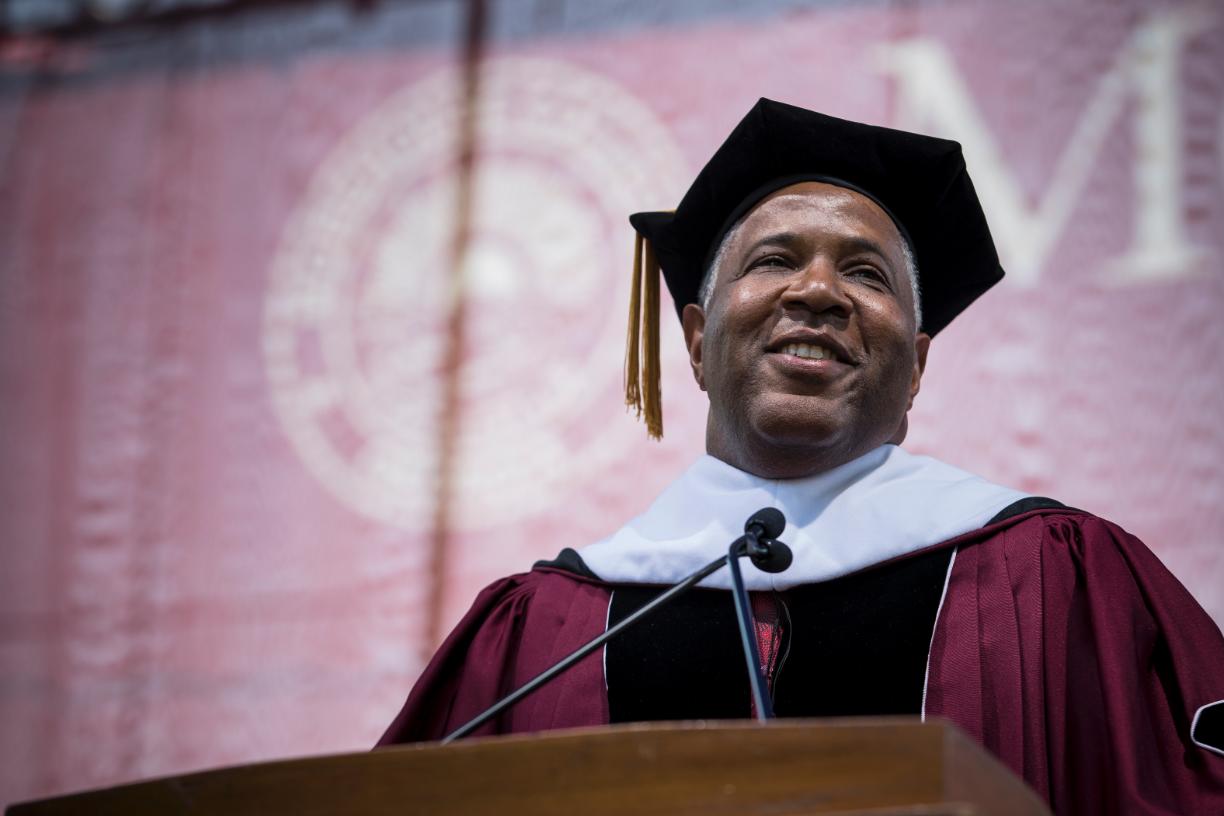 Robert F. Smith in academic regalia speaking at Morehouse College’s 2019 commencement