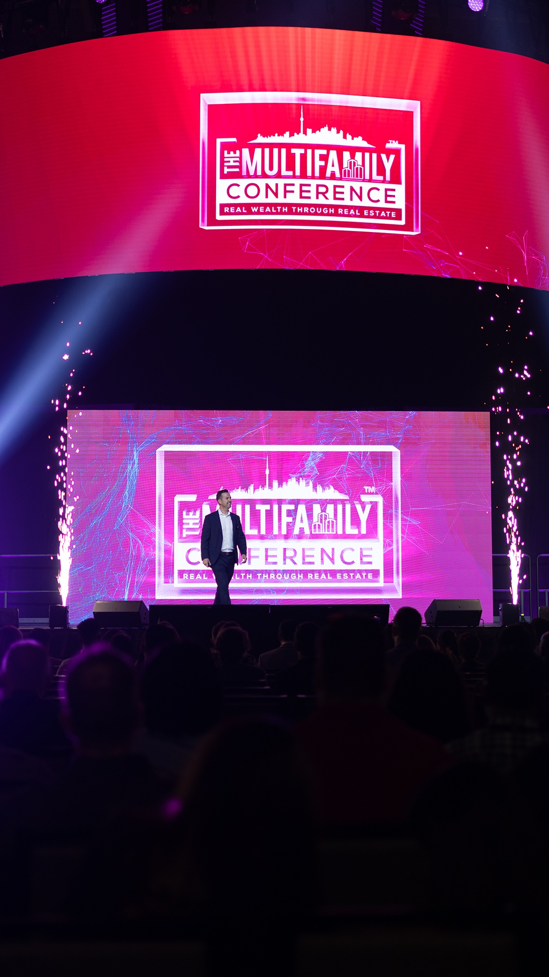 Robert Gauvreau speaking on stage in a photograph from his official media page