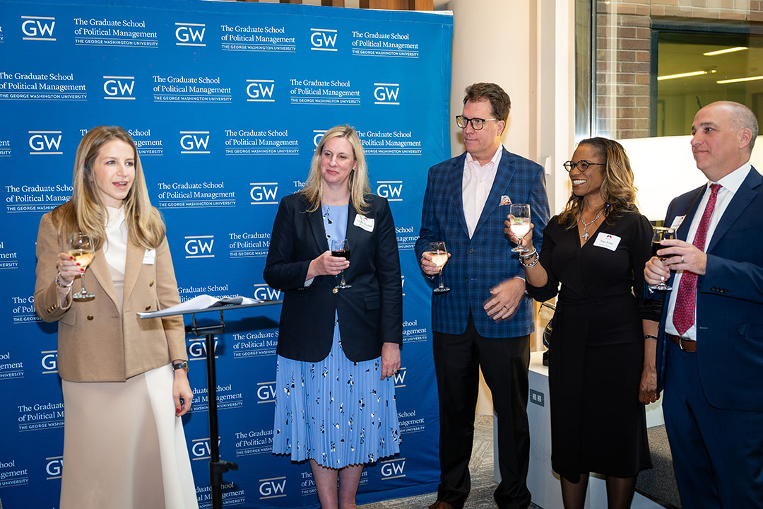 Robert Hoopes, center, joins Carly Cooperman, Tiffany Waddell, Traci Scott and Jordan Bernstein in a toast at GW’s 2024 alumni celebration