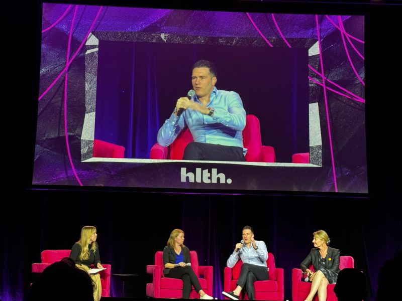 Robert Krayn speaking on a panel at the HLTH conference