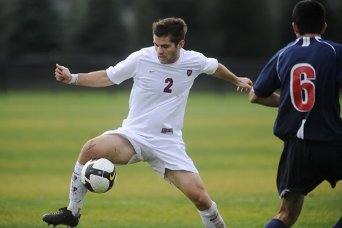 Robert Millock in Harvard’s number 2 jersey controlling the ball against Penn in 2009