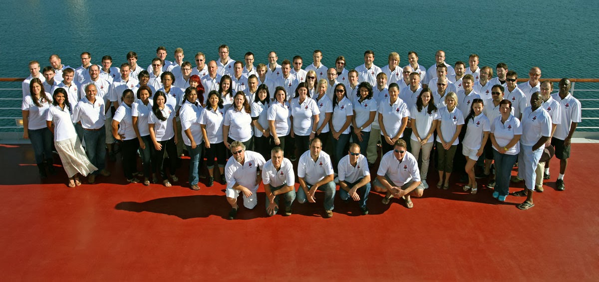 Xacti employees gathered on a ship’s deck during the company’s tenth-anniversary Mediterranean cruise