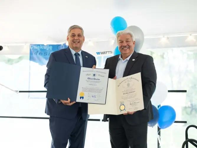 Robert Pagano, right, at Watts’ 150th anniversary event, with state senator Bruce Tarr and commemorative citations