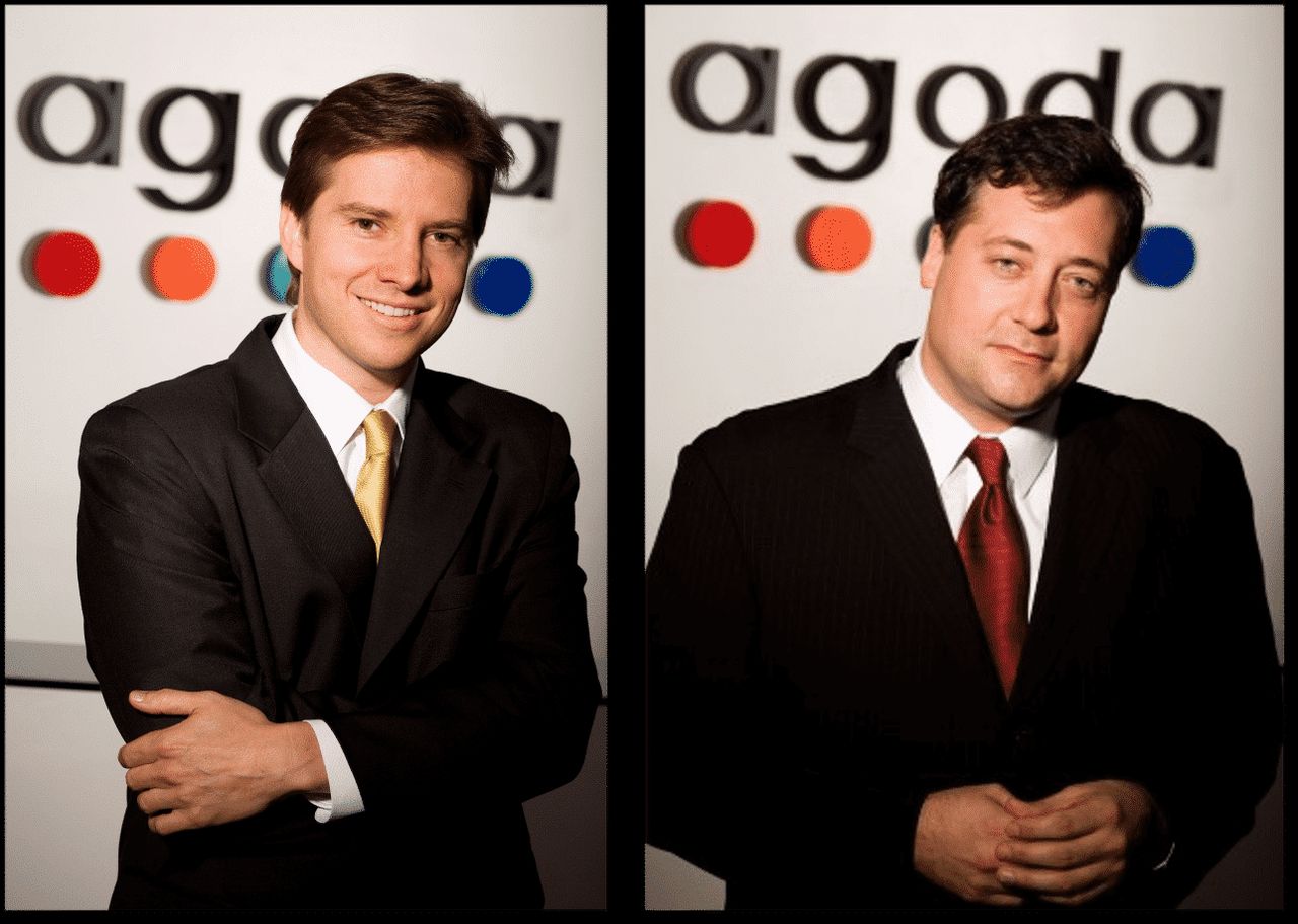 Agoda co-founders Michael Kenny on the left and Robert Rosenstein on the right, pictured against Agoda branding