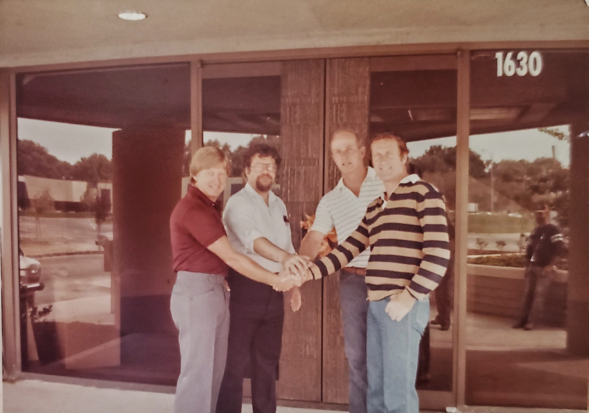 Linear Technology founders Bob Swanson, Bob Dobkin, Brian Hollins and Brent Welling outside a building