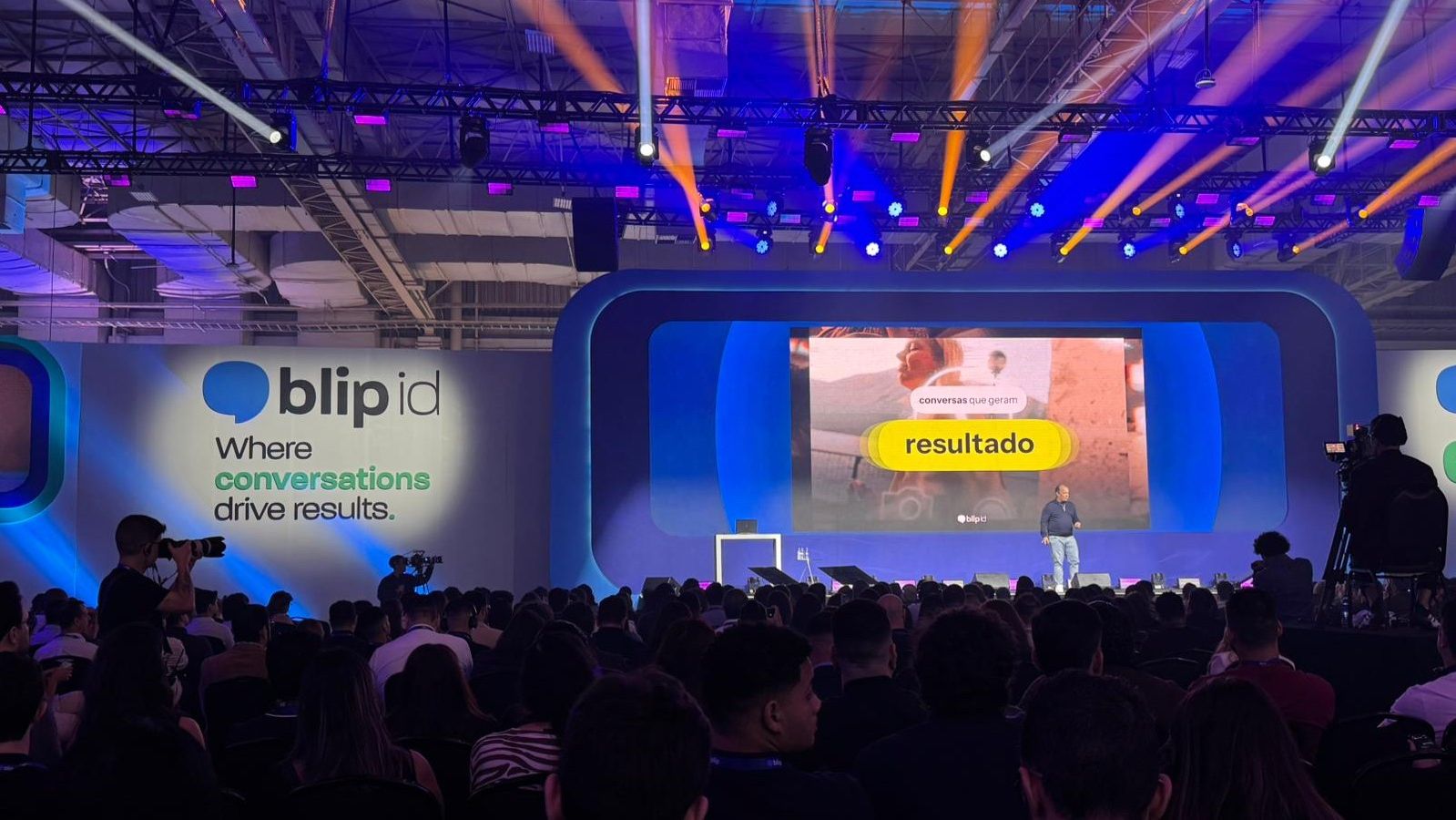 Roberto Oliveira speaking to an audience on the Blip id stage in São Paulo